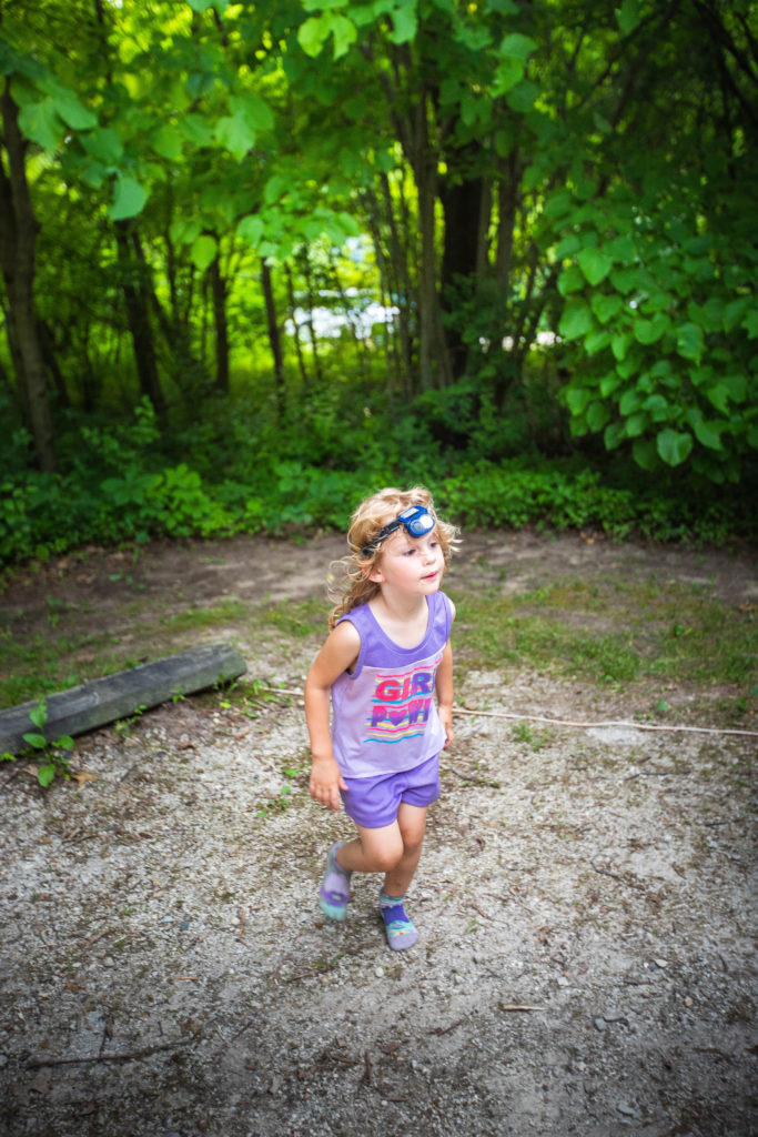 4 year old using a head lamp while tent camping