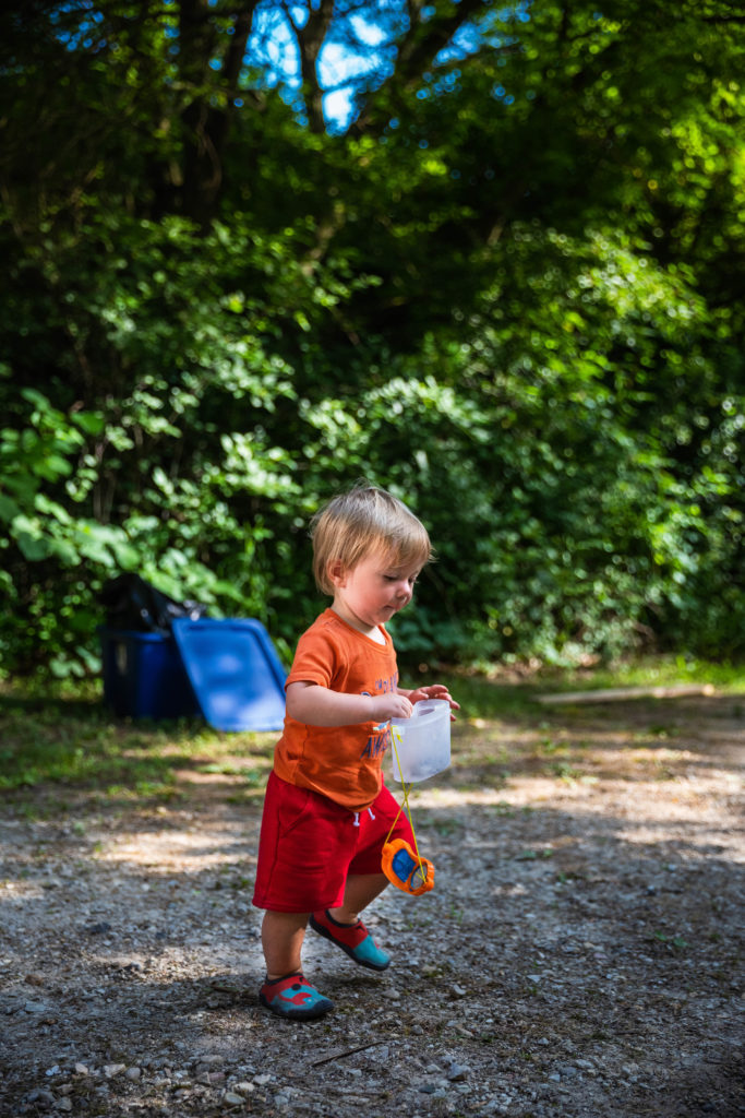 one year old catching bugs with bug catcher set | tent camping with toddlers