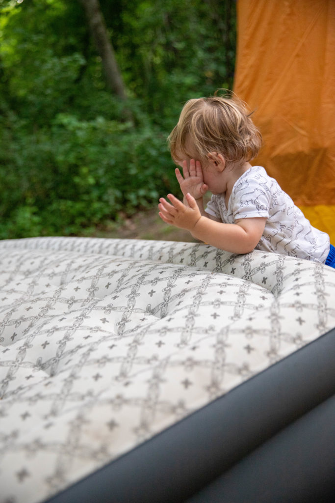 one year old playing outside while tent camping | camping with a toddler for the first time