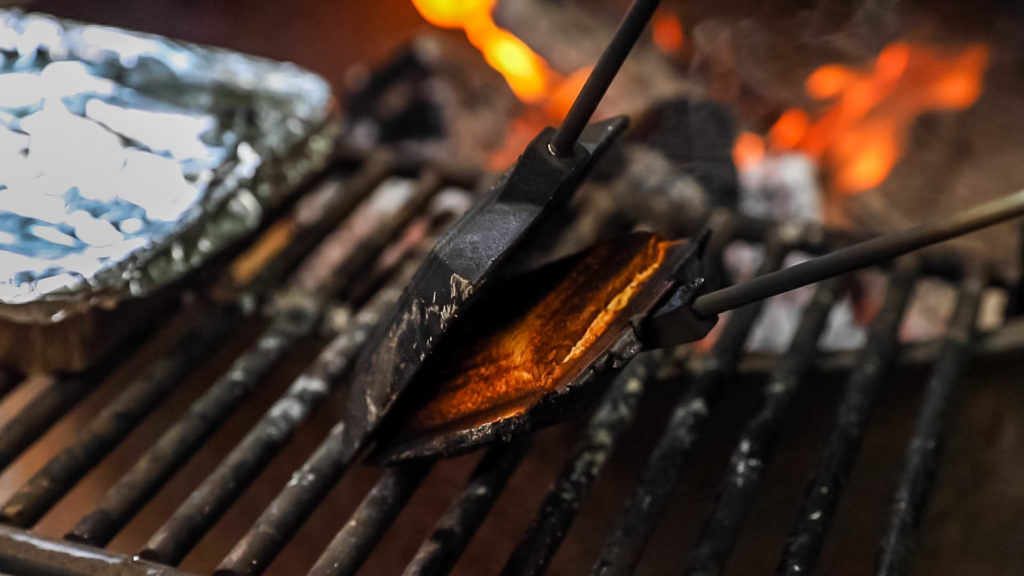Hobo pie maker being used over a campfire