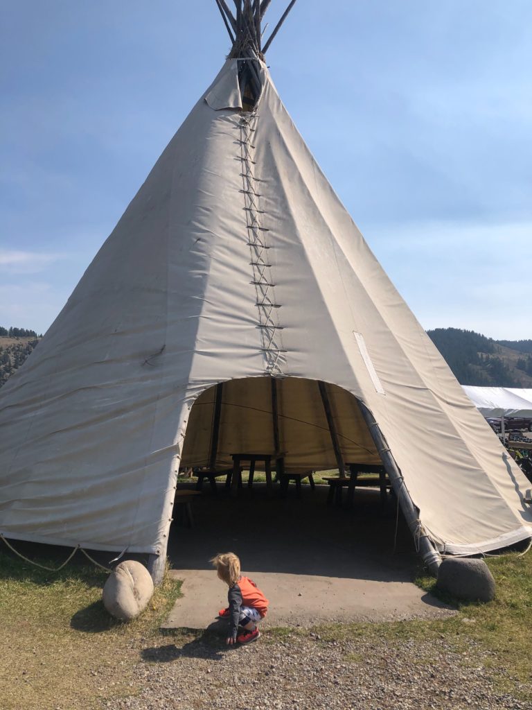 One year old playing near a teepee at Dornan's Chuckwagon in Moose, WY