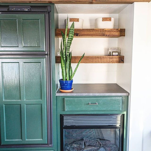 RV interior with wood ledges and decorated with a plant