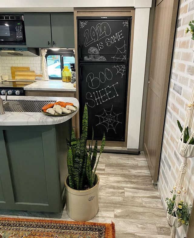 Camper interior with a chalk painted fridge