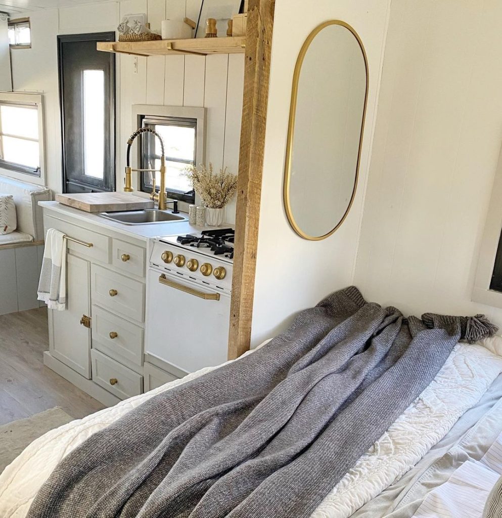 RV interior of bedroom mirror with gold fixtures