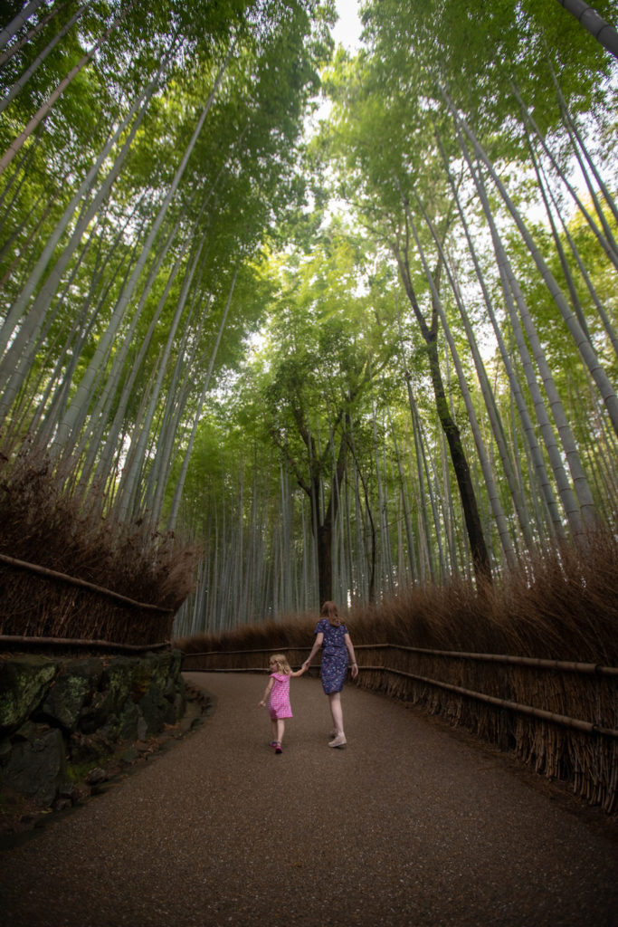 Mom and daughter walking through Bamboo grove in Arashiyama Kyoto