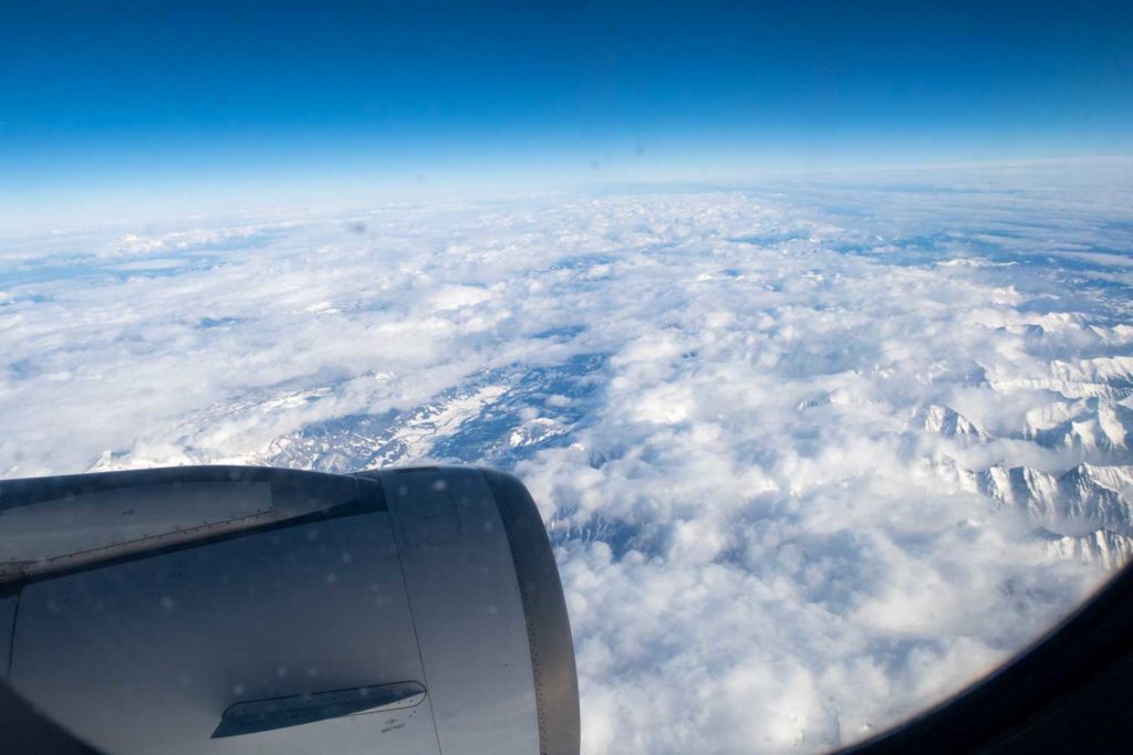 View of the clouds below from an airplane window