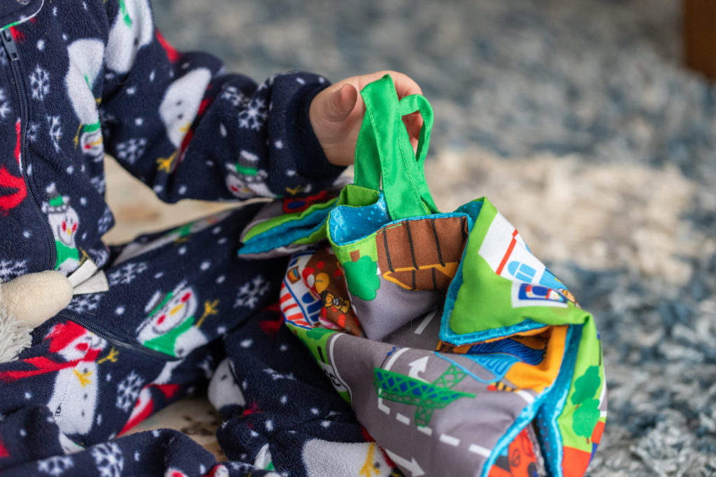 1-year-old playing with Melissa & Doug Take-Along Town Play Mat