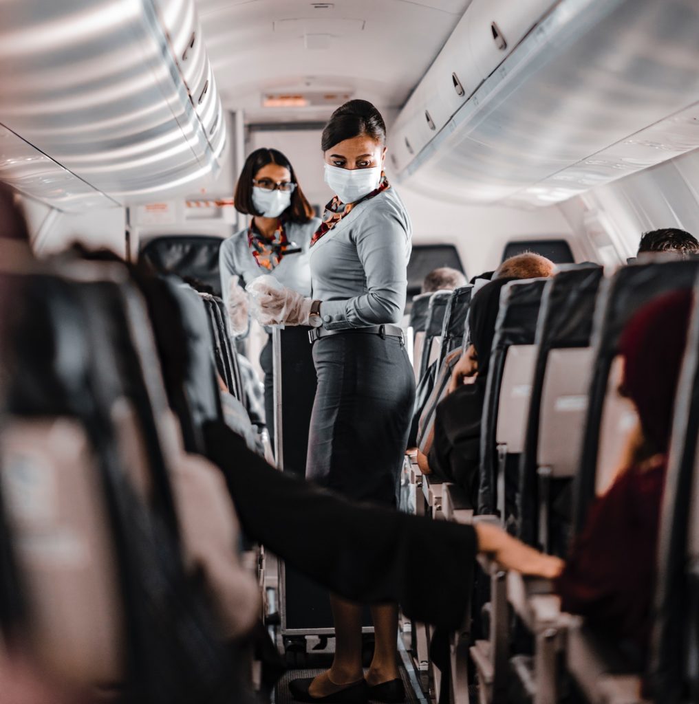 Flight attendants helping a passenger