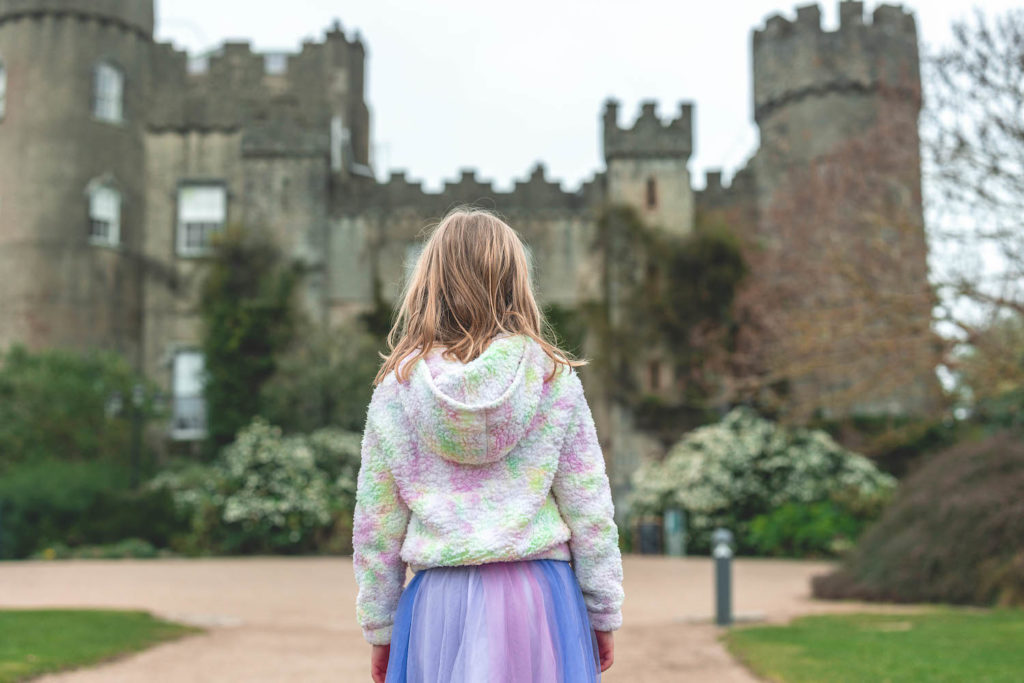 girl standing in front of Malahide Castle in Dublin Ireland