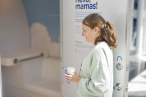 mom entering mamava breastfeeding pod
