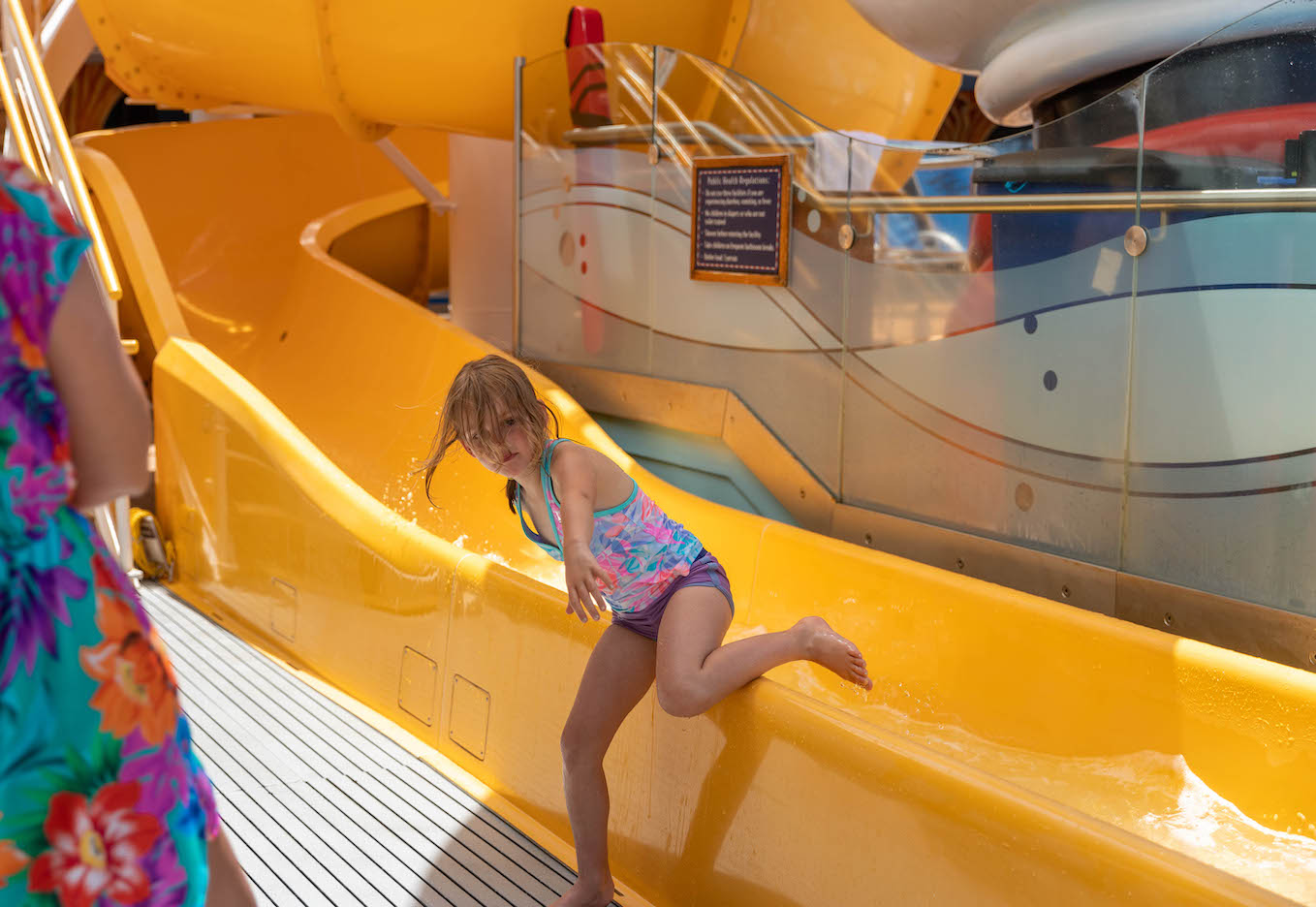 girl coming off the waterslide on the disney dream