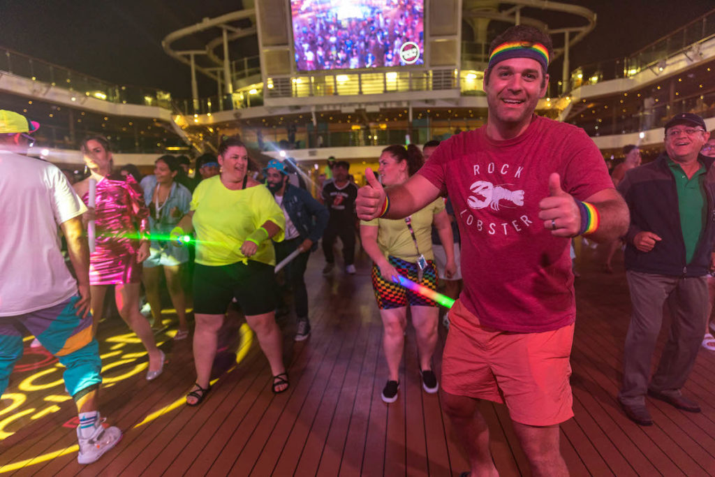 Carnival cruise panorama 80s neon night deck party